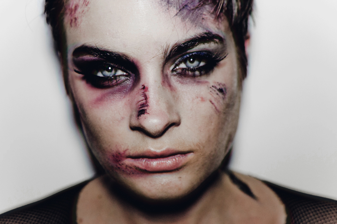 Brunette female model with dark makeup and bruises by Nika Vaughan