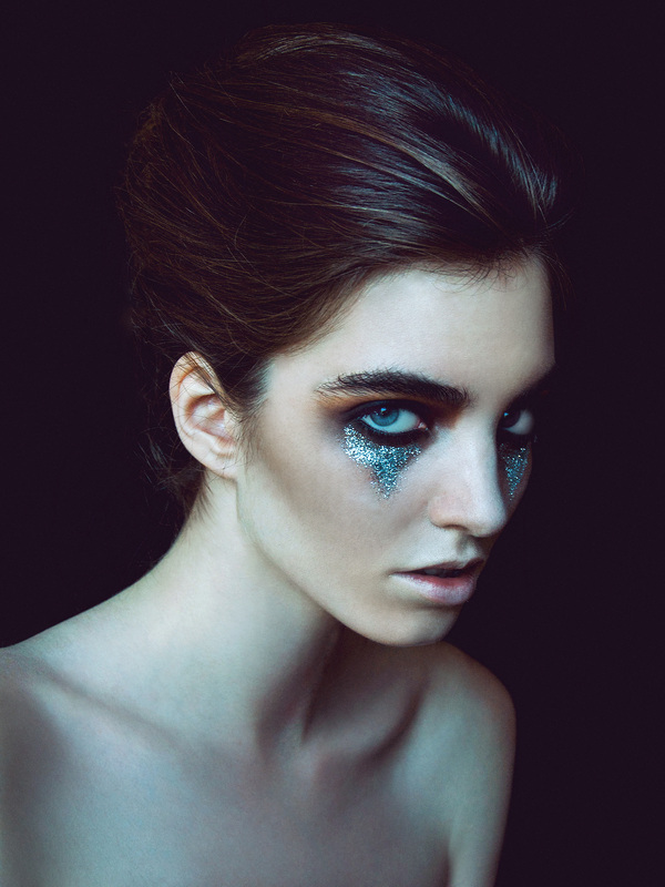 Brunette female model with silver glitter and dark makeup by Nika Vaughan