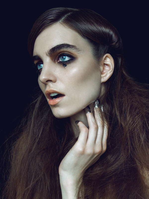 Brunette female model with black glitter and dark eye makeup by Nika Vaughan