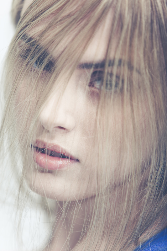 Blonde female model with hair over face makeup by Nika Vaughan